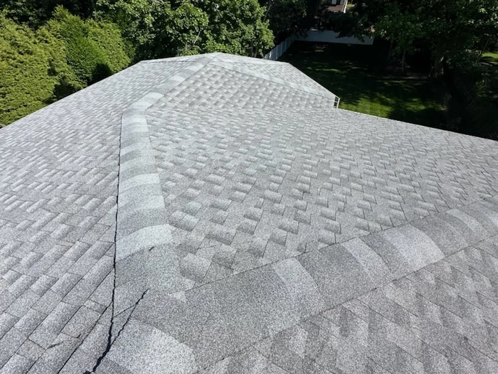 A finished gray architectural shingle roof seen along the ridge and hip lines